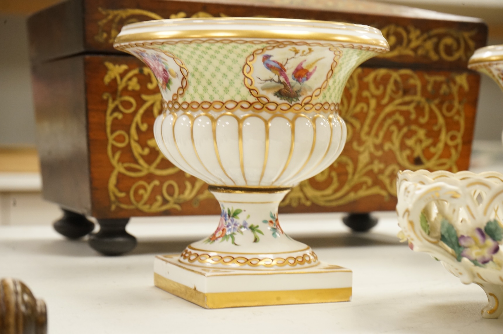 A pair of Dresden urns and a floral encrusted basket, tallest 15cm